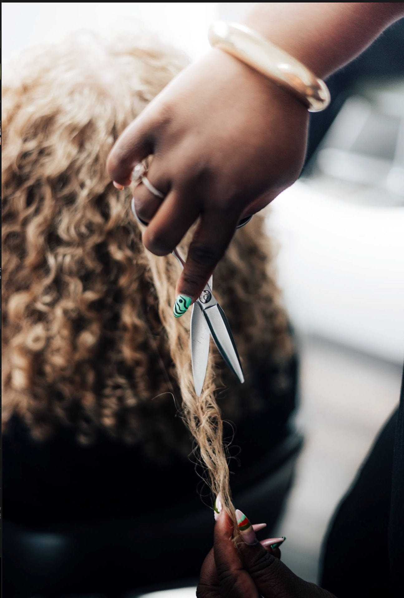 Stylist trimming defined natural curls curl by curl